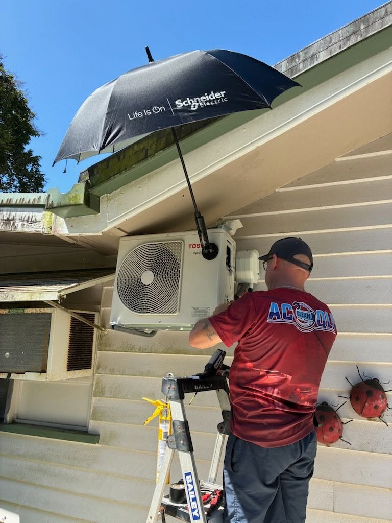 ACcleanQLD technician installing a new Toshiba split system outdoor unit in Tully