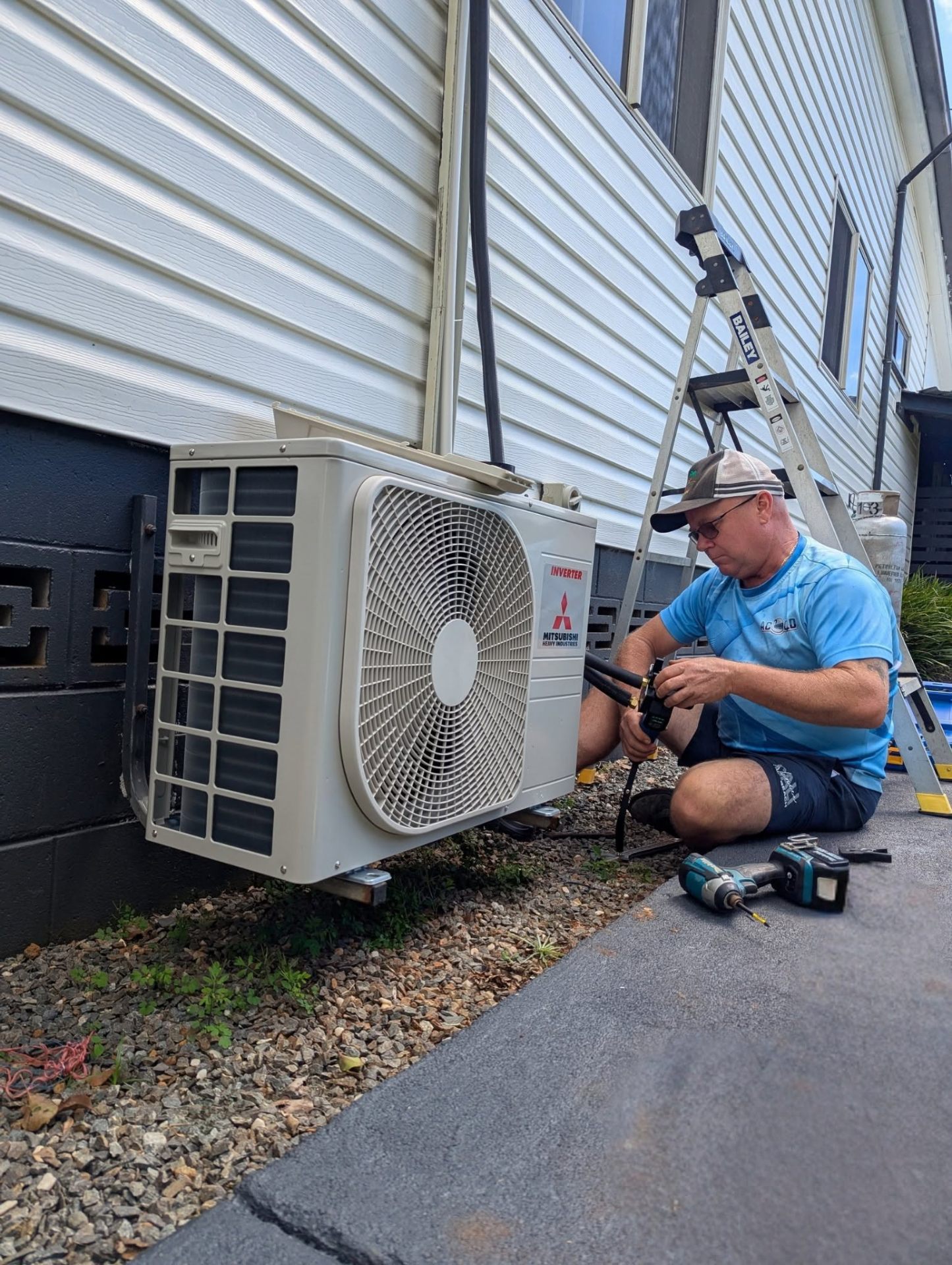 ACcleanQLD technician commissioning a Mitsubishi Heavy Industries split system